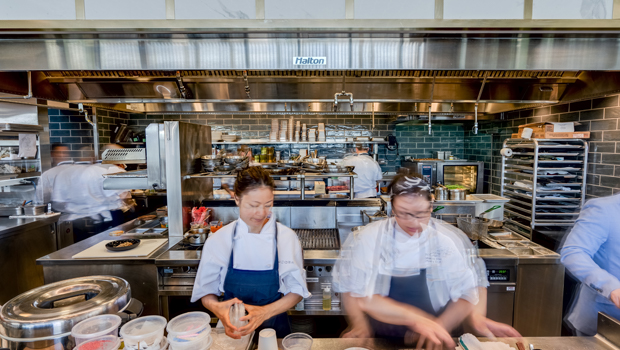 A theatre-like open kitchen and bar that invites guests to engage with the chef
